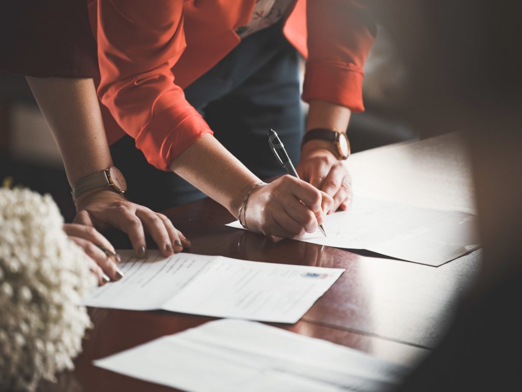two women filling out paperwork