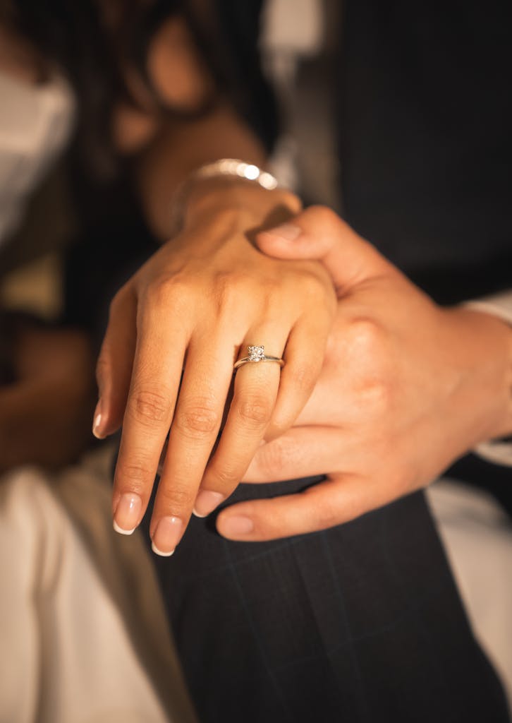 Close-up of a couple's hands with an elegant engagement ring, showcasing love in Oaxaca, Mexico.